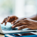 Hand typing on a keyboard.