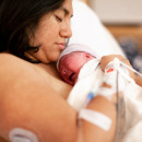 Mother Holding Brand New Baby In Hospital Delivery Room